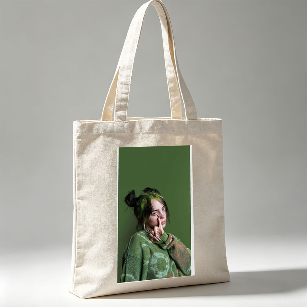 Billie Eilish in Studio Portrait Wearing Green Knit Sweater with Hair in Buns and Fingers on Face - Canvas tote bags