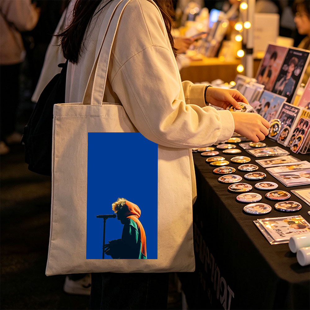 Troye Sivan Performing on Stage with Microphone Against Blue Background - Canvas tote bags
