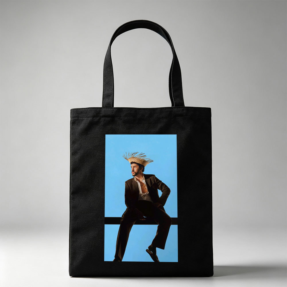 Bad Bunny in a Bold Fashion Statement Wearing a Straw Hat and Suit Against a Blue Background - Canvas tote bags