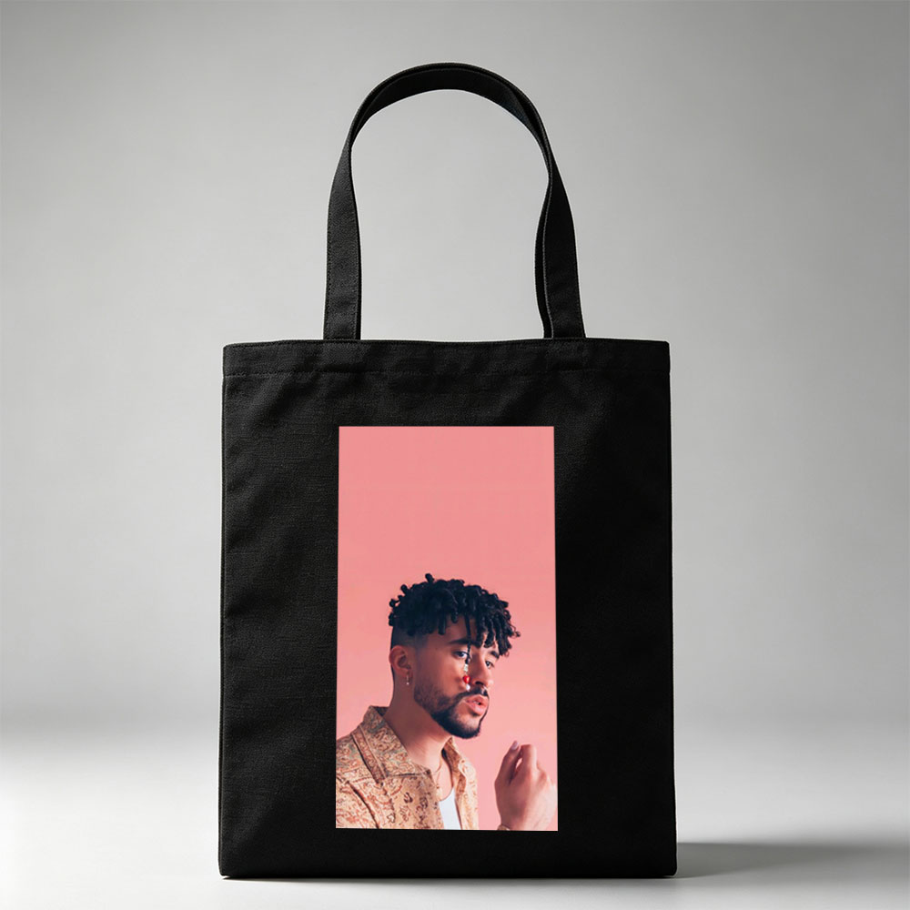 Bad Bunny in a Stylish Pose Against a Pink Background Wearing a Patterned Shirt and Red Nose Jewelry - Canvas tote bags