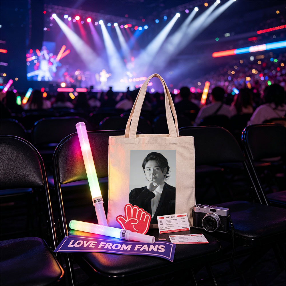 Kai from EXO in a dramatic pose with finger on lips, wearing a sparkling black suit and white shirt, set against a neutral background. - Canvas tote bags