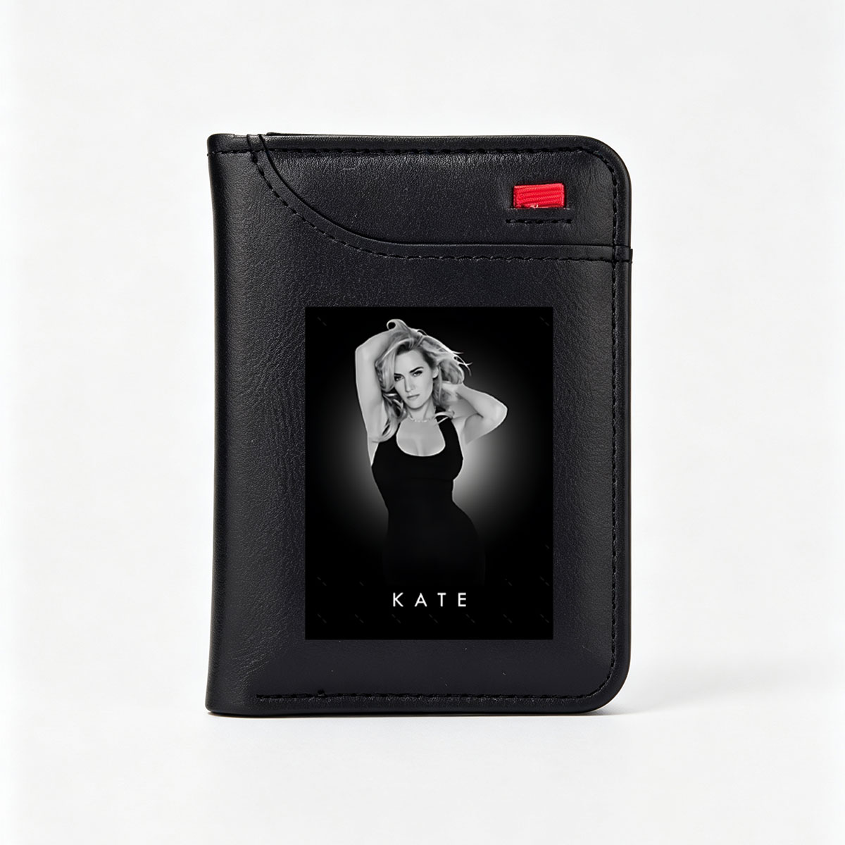 Kate Winslet in a striking black dress, posing with hands in her hair against a dark background. - Vertical Style Wallet