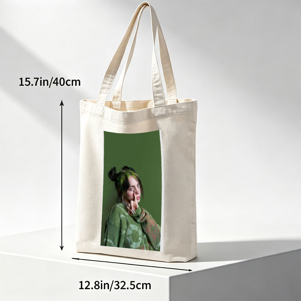 Billie Eilish in Studio Portrait Wearing Green Knit Sweater with Hair in Buns and Fingers on Face - Canvas tote bags