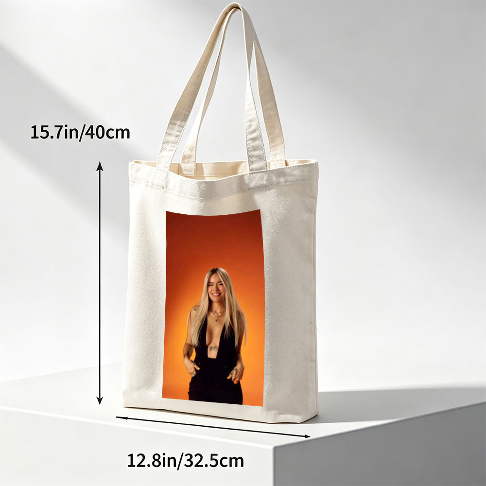 Bebe Rexha in a Bold Black Outfit Against a Vibrant Orange Background, Smiling with Confidence - Canvas tote bags