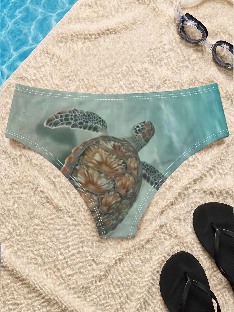 Sea turtle swimming gracefully over sandy ocean floor -  Men's swim trunks