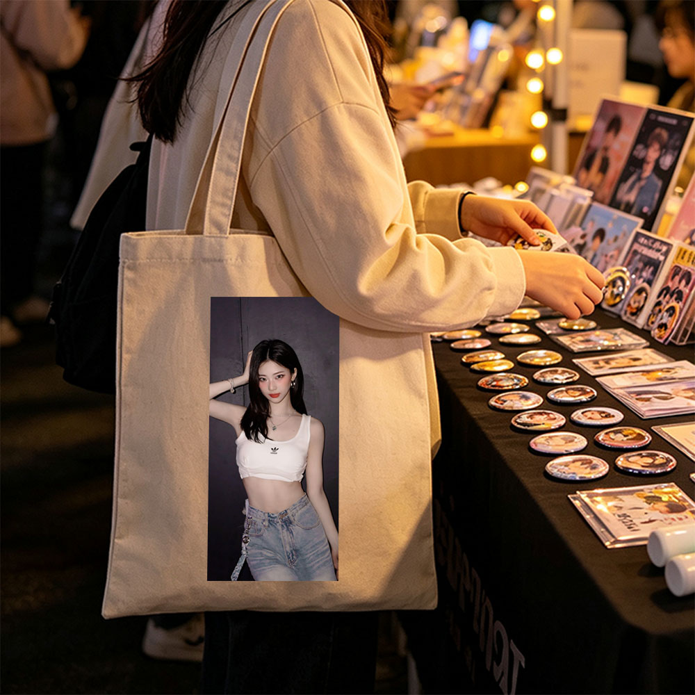 Korean Celebrity in Casual Outfit Wearing White Adidas Crop Top and High-Waisted Jeans Against Dark Background - Canvas tote bags