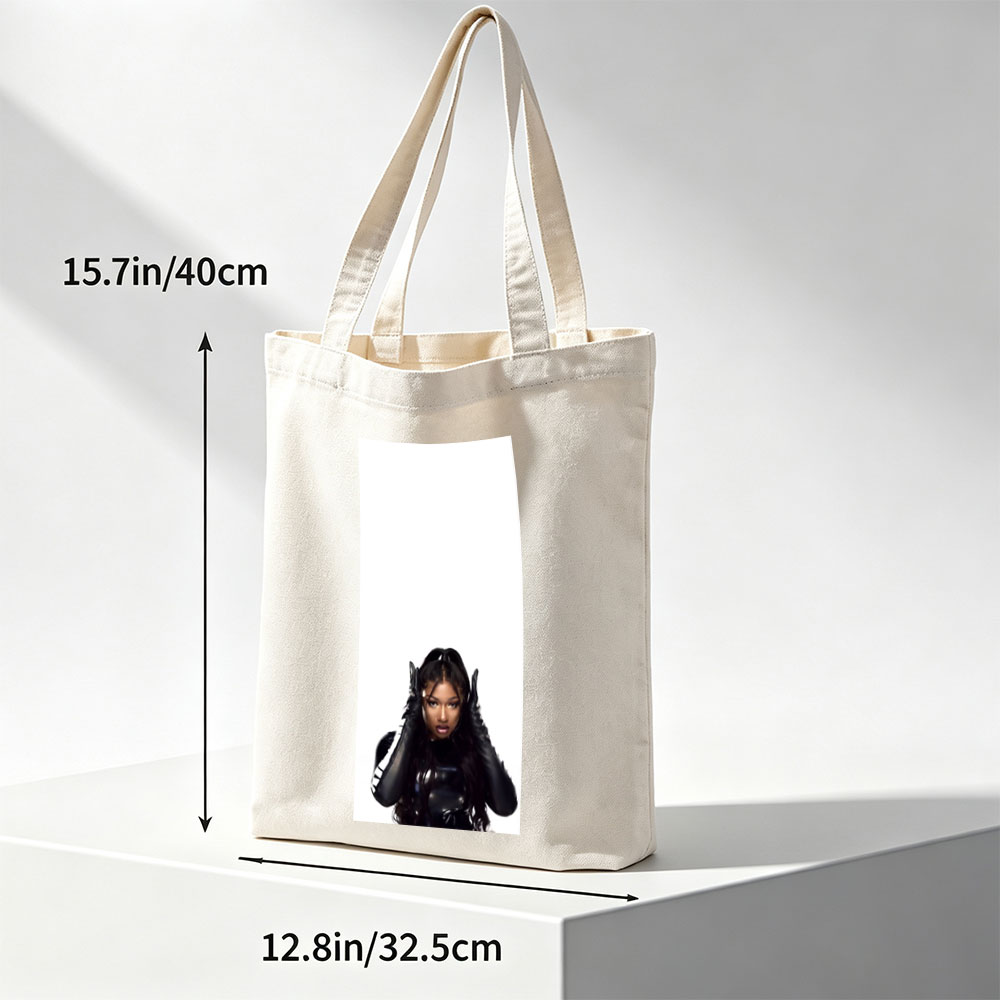 Megan Thee Stallion in a Bold Black Outfit with Hands on Head Against White Background - Canvas tote bags