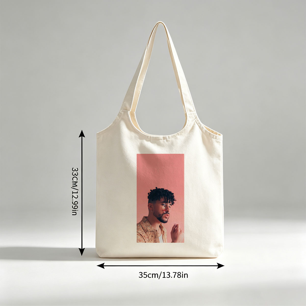Bad Bunny in a Stylish Pose Against a Pink Background Wearing a Patterned Shirt and Red Nose Jewelry - Canvas shoulder bags/