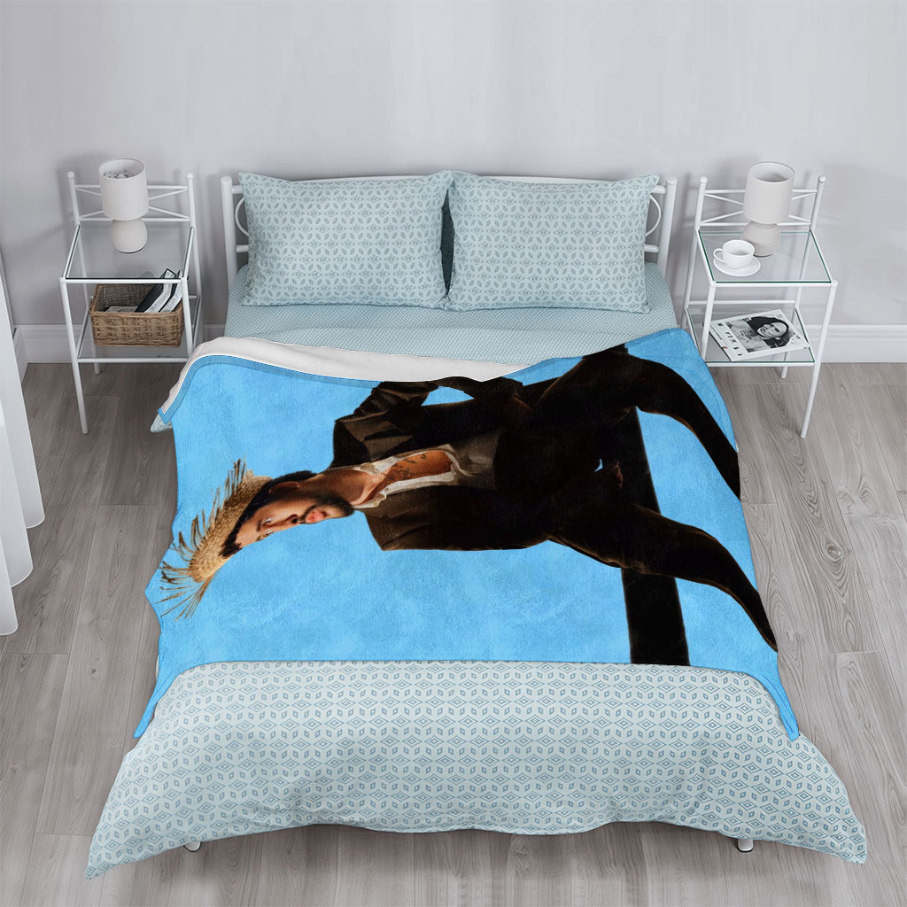 Bad Bunny in a Bold Fashion Statement Wearing a Straw Hat and Suit Against a Blue Background - Blankets