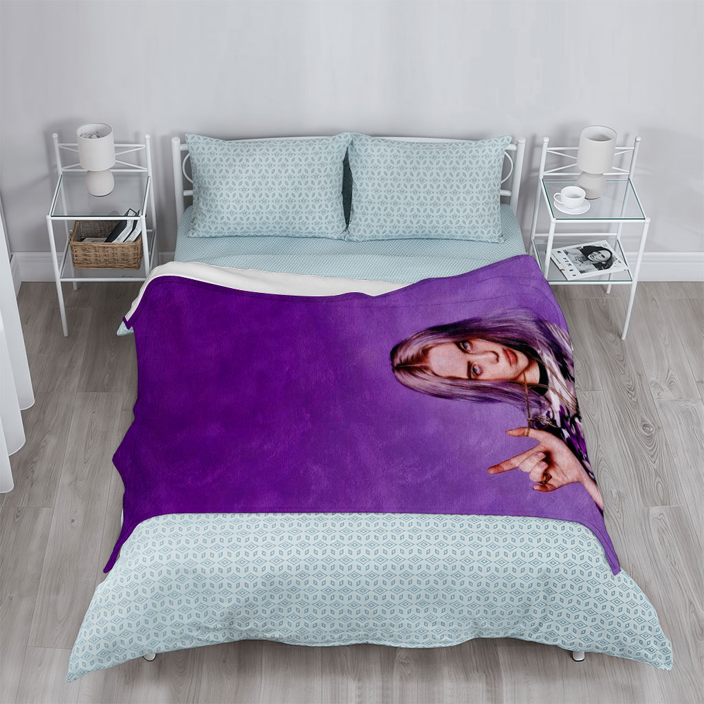 Billie Eilish in Purple Camo Outfit Making Hand Gesture Against Vibrant Background - Blankets