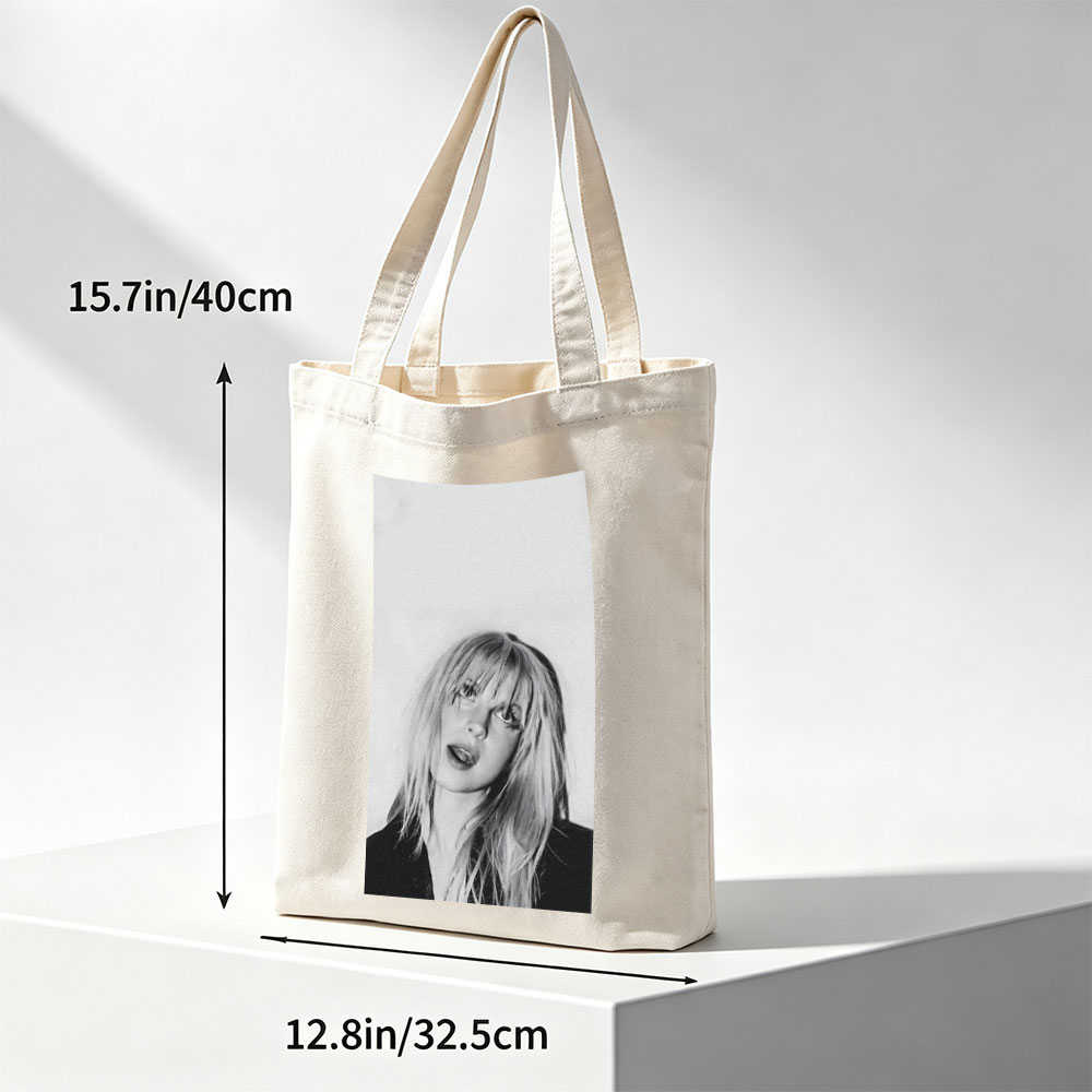 Bebe Rexha in a striking black and white portrait with tousled blonde hair and bold expression - Canvas tote bags