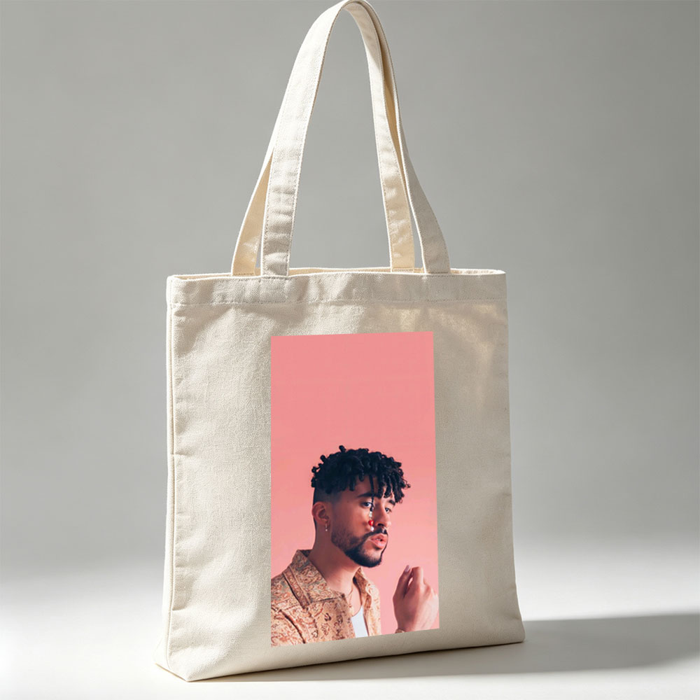 Bad Bunny in a Stylish Pose Against a Pink Background Wearing a Patterned Shirt and Red Nose Jewelry - Canvas tote bags