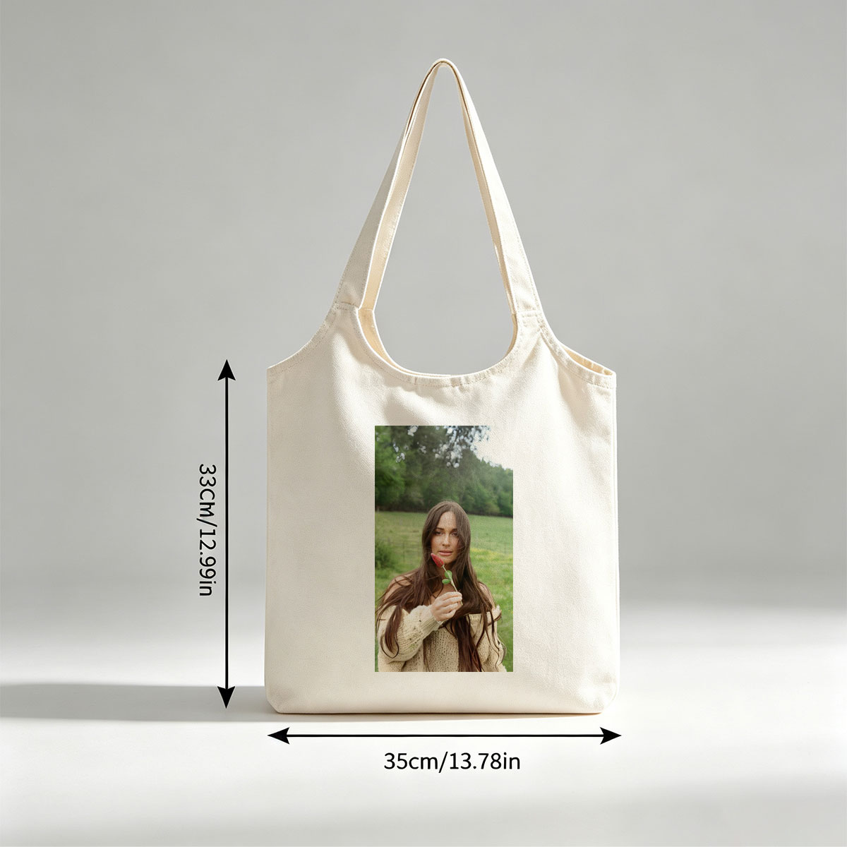Lily-Rose Depp in a Serene Field Holding a Red Flower - Canvas shoulder bags/