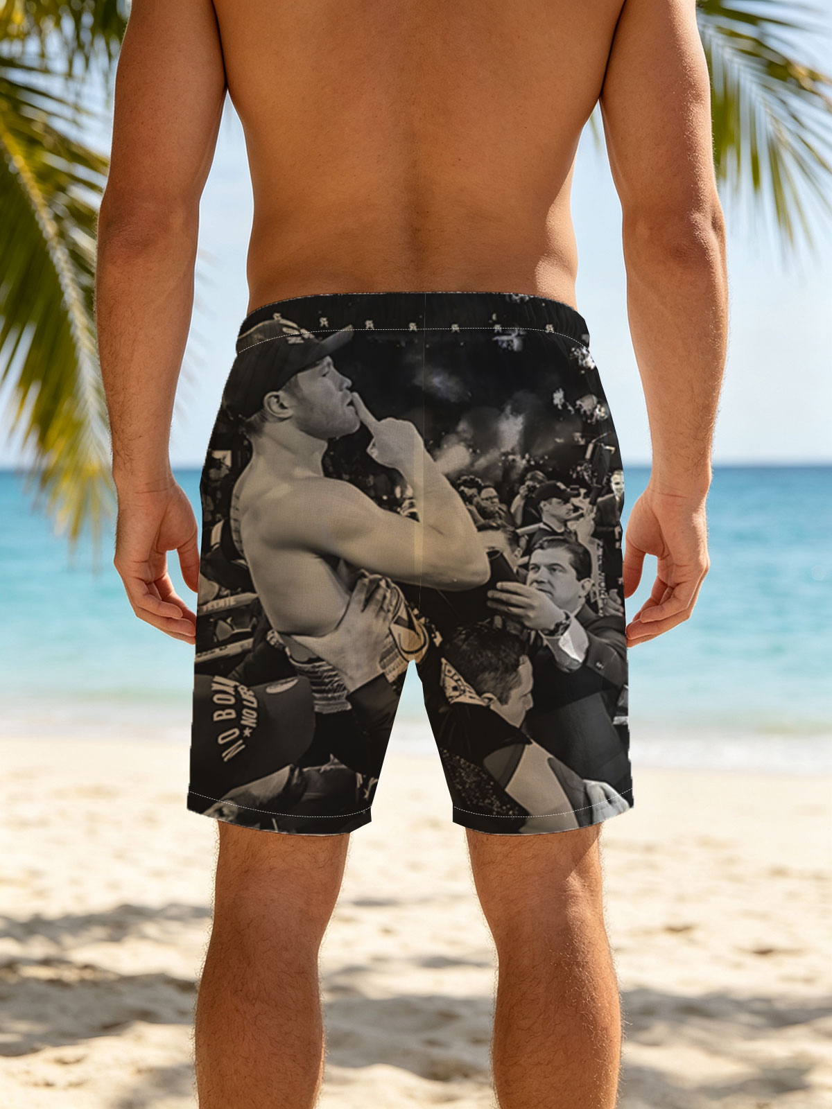 Conor McGregor celebrates victory in the octagon, surrounded by team and fans. -  Beach shorts