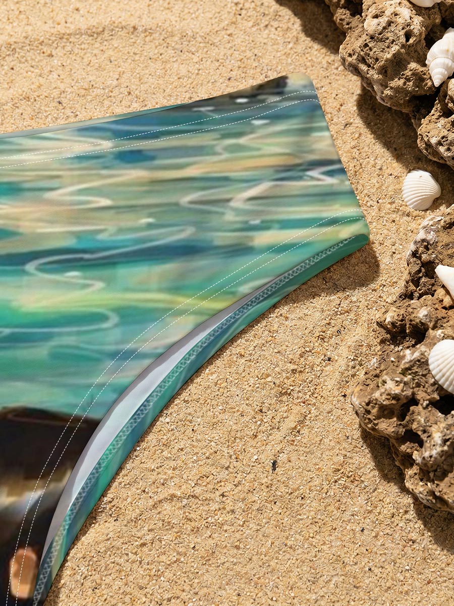 Woman swimming in clear blue water near rocky shore -  Men's swim trunks