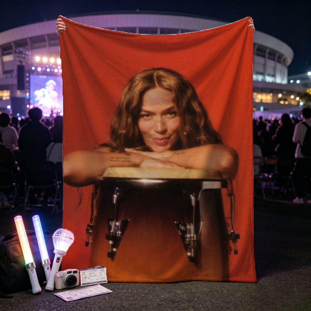 Maren Morris Leaning on a Conga Drum Against a Red Background - Blankets