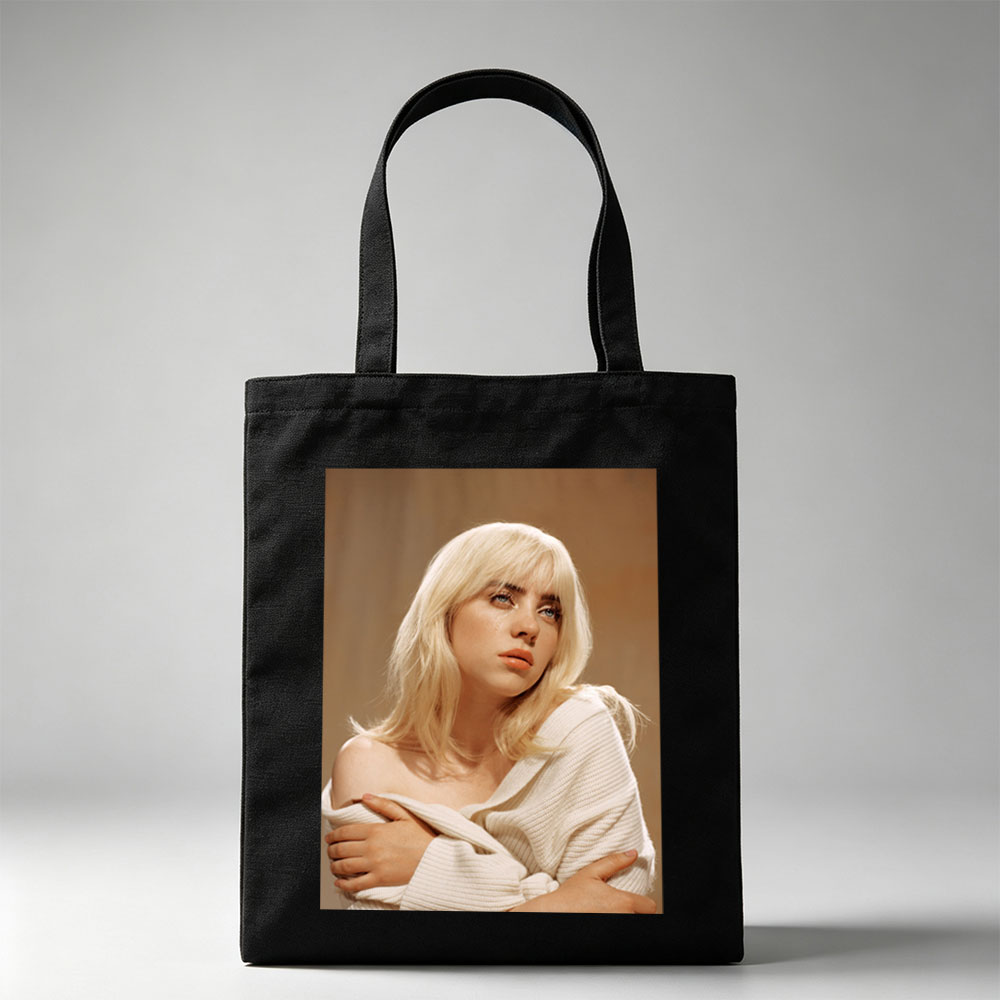 Billie Eilish in a Soft Portrait Wearing a White Off-Shoulder Sweater with Blonde Hair and Blue Eyes - Canvas tote bags