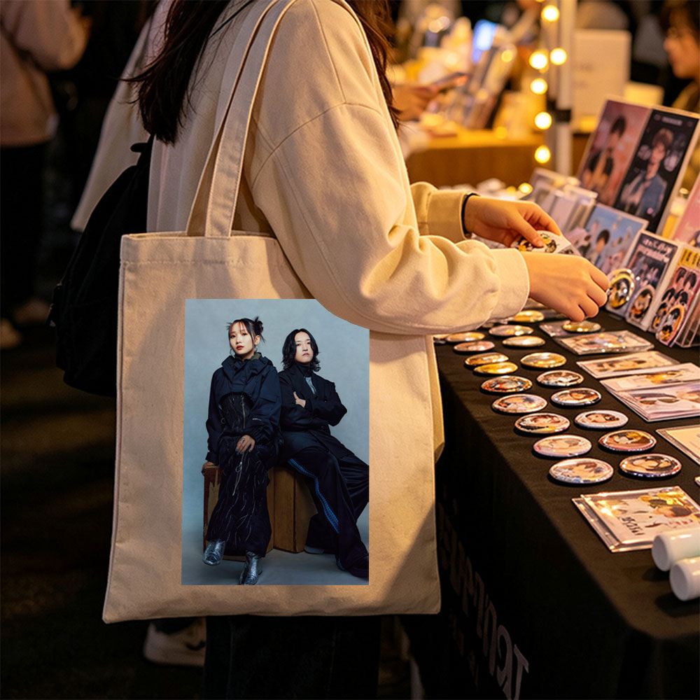 YOASOBI in a Stylish Studio Portrait Featuring Two Members Dressed in Dark, Edgy Fashion Sitting on Wooden Crates Against a Neutral Background - Canvas tote bags