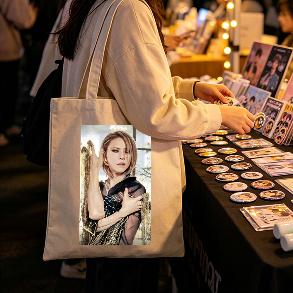 Cher in a Dramatic Pose Wearing a Black and Gold Outfit with Flowing Fabric - Canvas tote bags