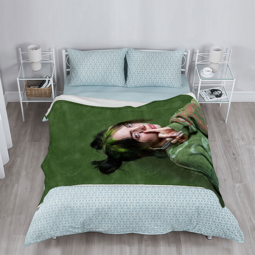 Billie Eilish in Studio Portrait Wearing Green Knit Sweater with Hair in Buns and Fingers on Face - Blankets