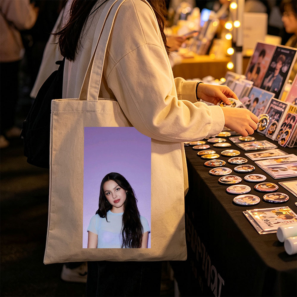 Olivia Rodrigo in a Soft Blue Top Against a Purple Gradient Background - Canvas tote bags