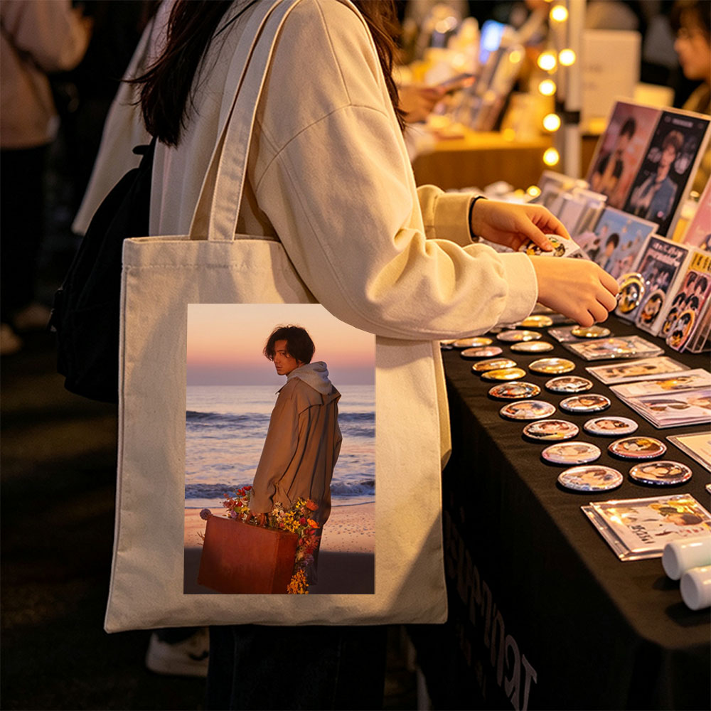 Takuya Kimura on Beach at Sunset Holding Flower-Adorned Suitcase - Canvas tote bags