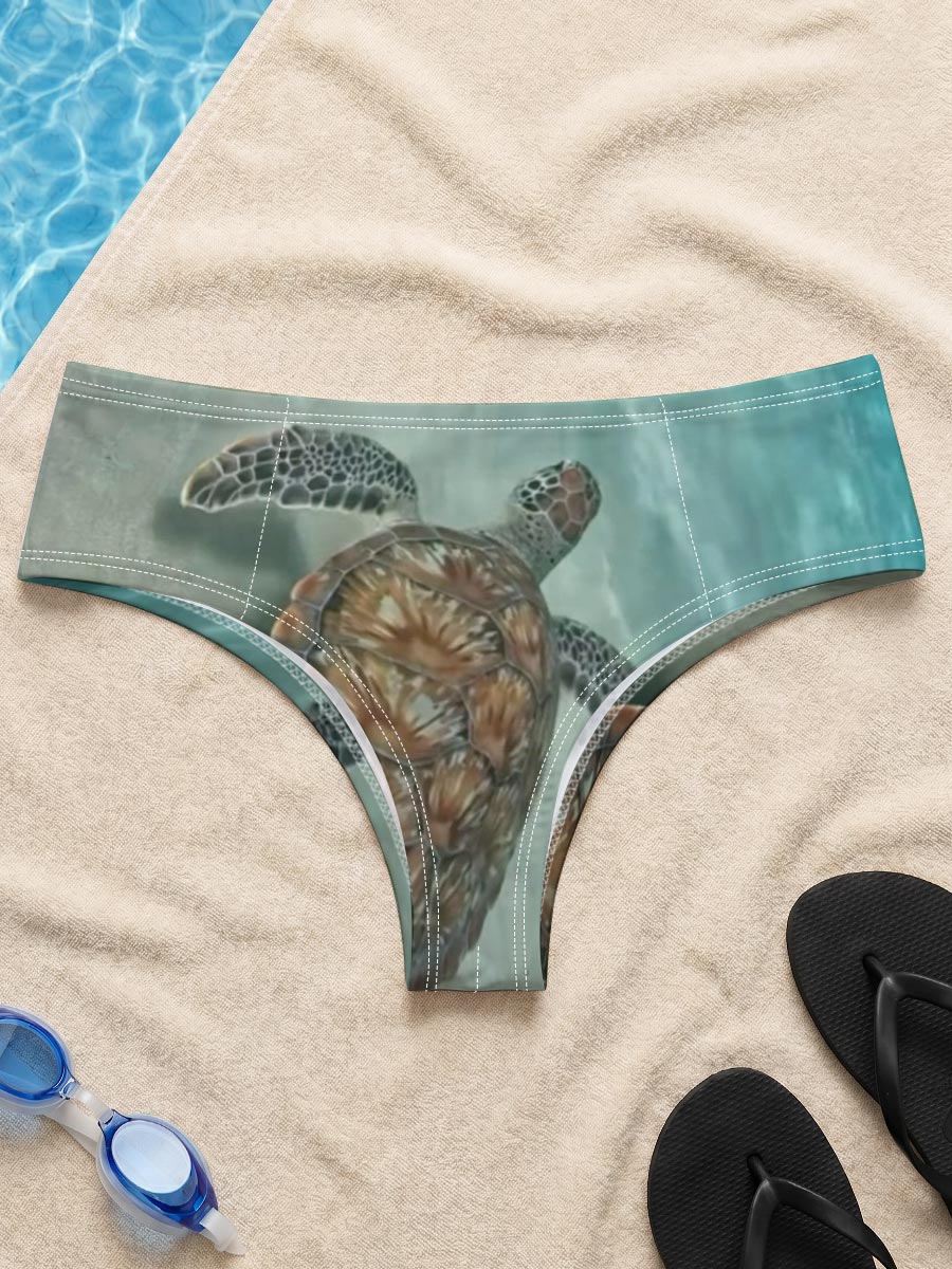 Sea turtle swimming gracefully over sandy ocean floor -  Men's swim trunks