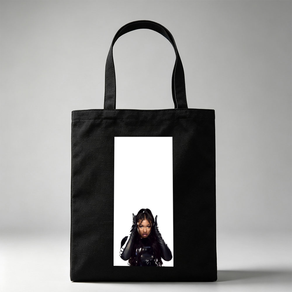 Megan Thee Stallion in a Bold Black Outfit with Hands on Head Against White Background - Canvas tote bags