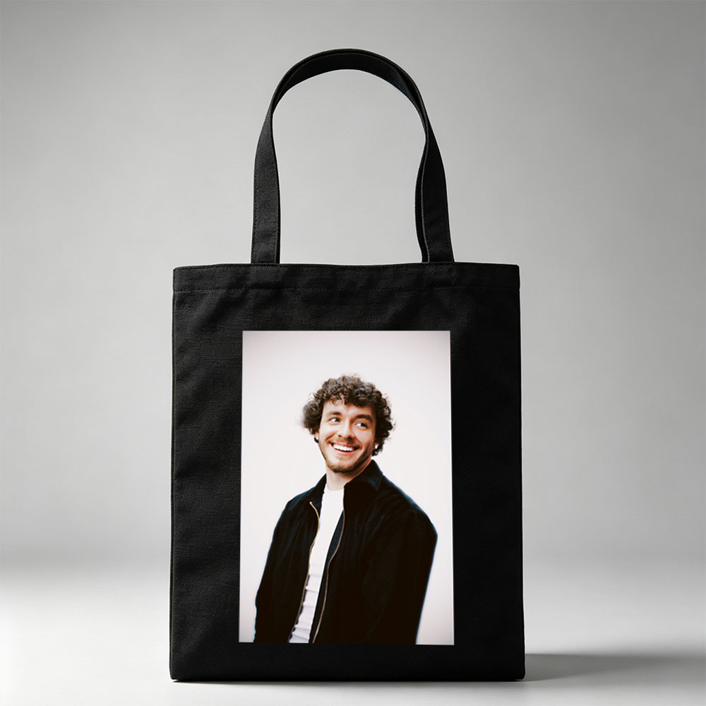 Matt Healy of The 1975 in a Candid Moment Wearing a Black Jacket and White Shirt Against a Plain Background - Canvas tote bags