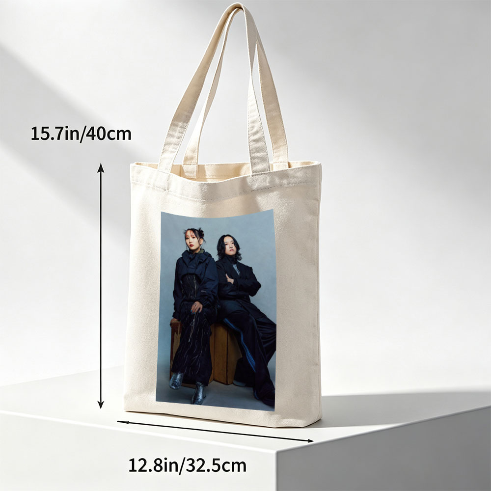 YOASOBI in a Stylish Studio Portrait Featuring Two Members Dressed in Dark, Edgy Fashion Sitting on Wooden Crates Against a Neutral Background - Canvas tote bags