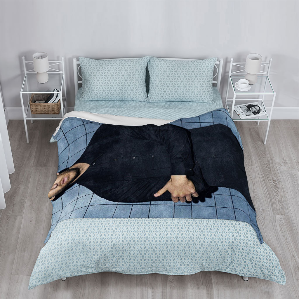 Calvin Harris in a Black Shirt and Pants Standing Against a Blue Tiled Wall with Arms Crossed - Blankets