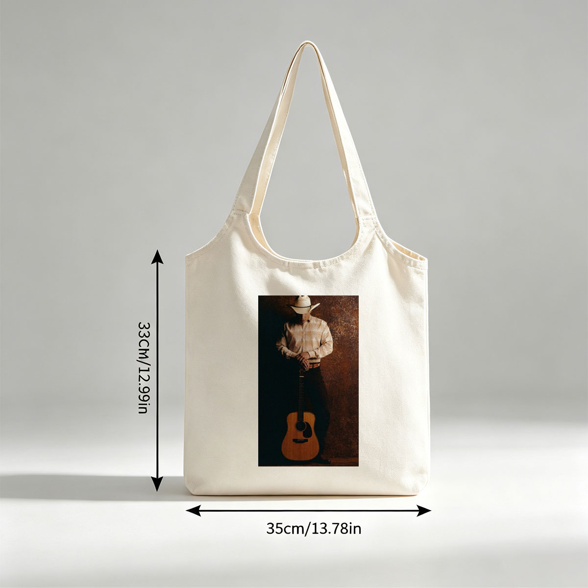 George Strait Holding Acoustic Guitar in Cowboy Attire Against Rustic Background - Canvas shoulder bags/