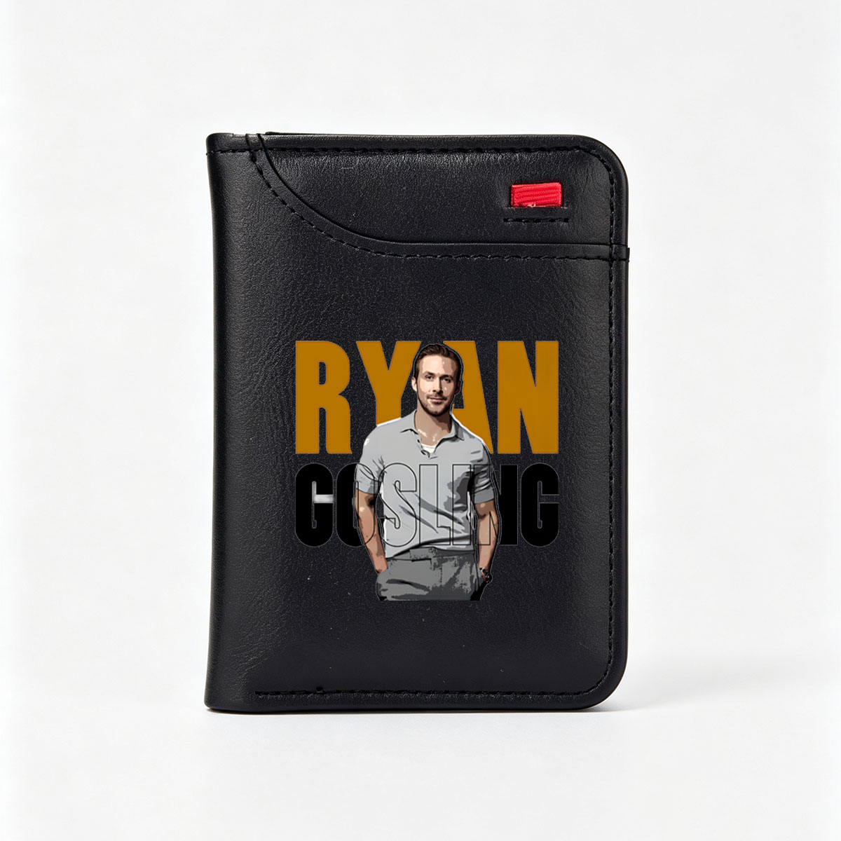 Ryan Gosling in a stylish gray polo shirt, standing confidently with hands in pockets, set against bold text backdrop. - Vertical Style Wallet