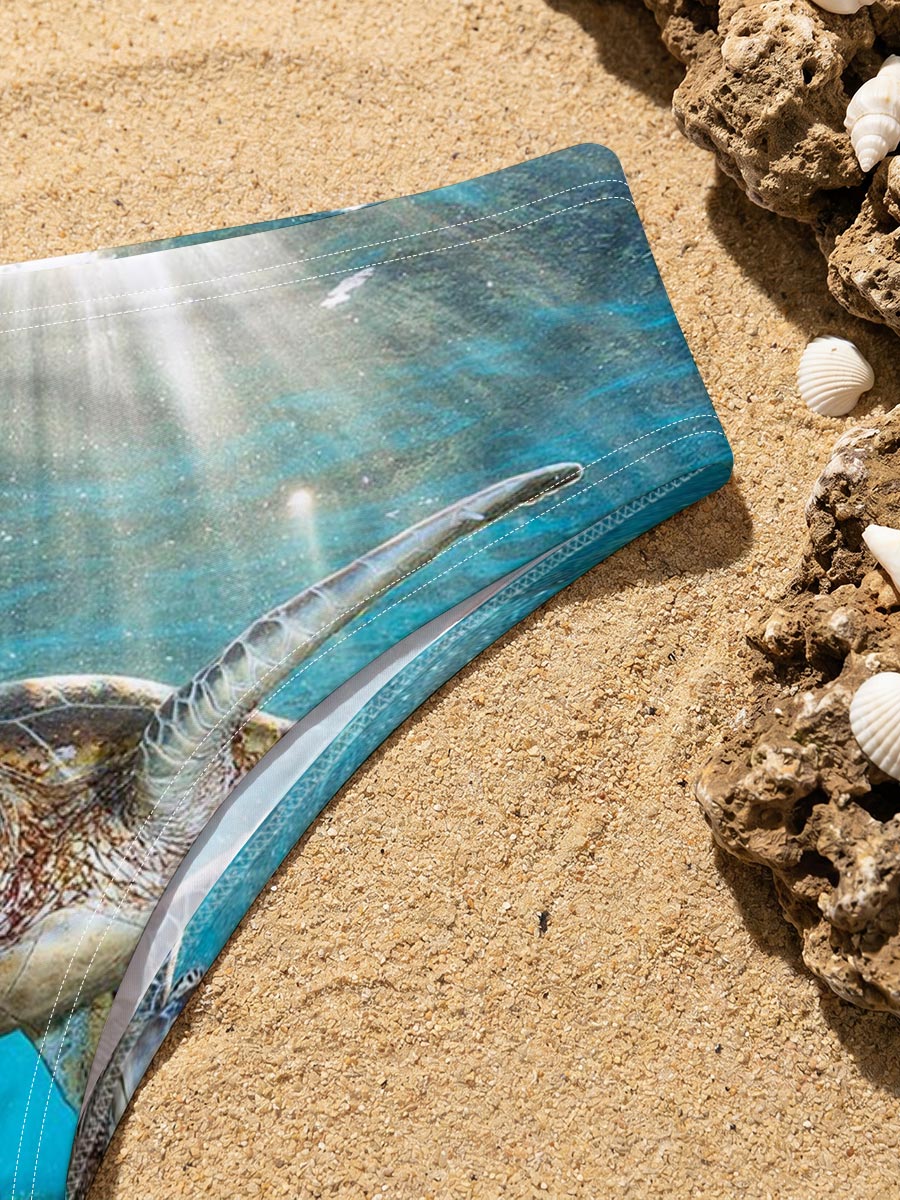 Sea turtle glides through sunlit coral reef -  Men's swim trunks