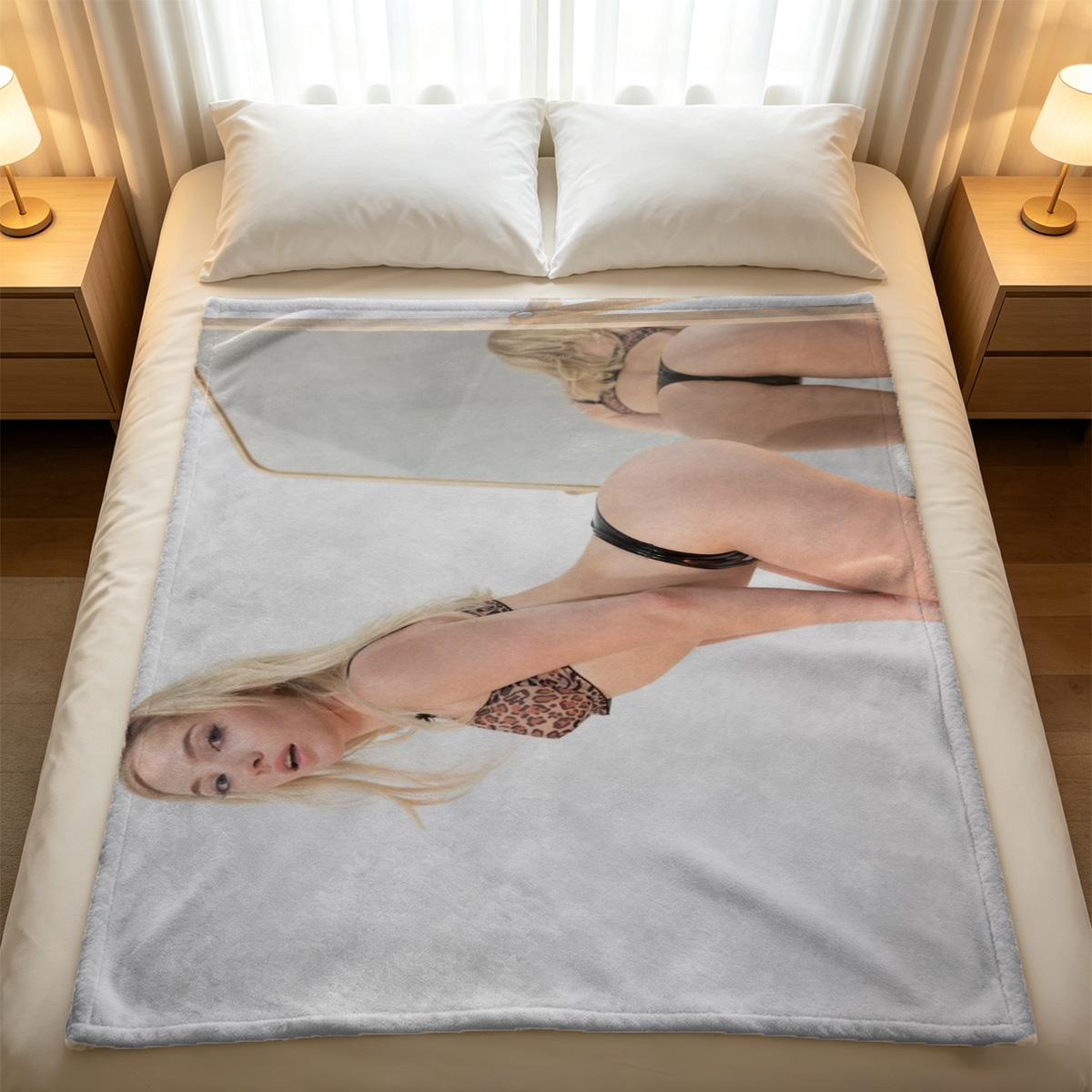 A young woman in a white button-up shirt kneeling on a bed in a sunlit bedroom. - Blanket
