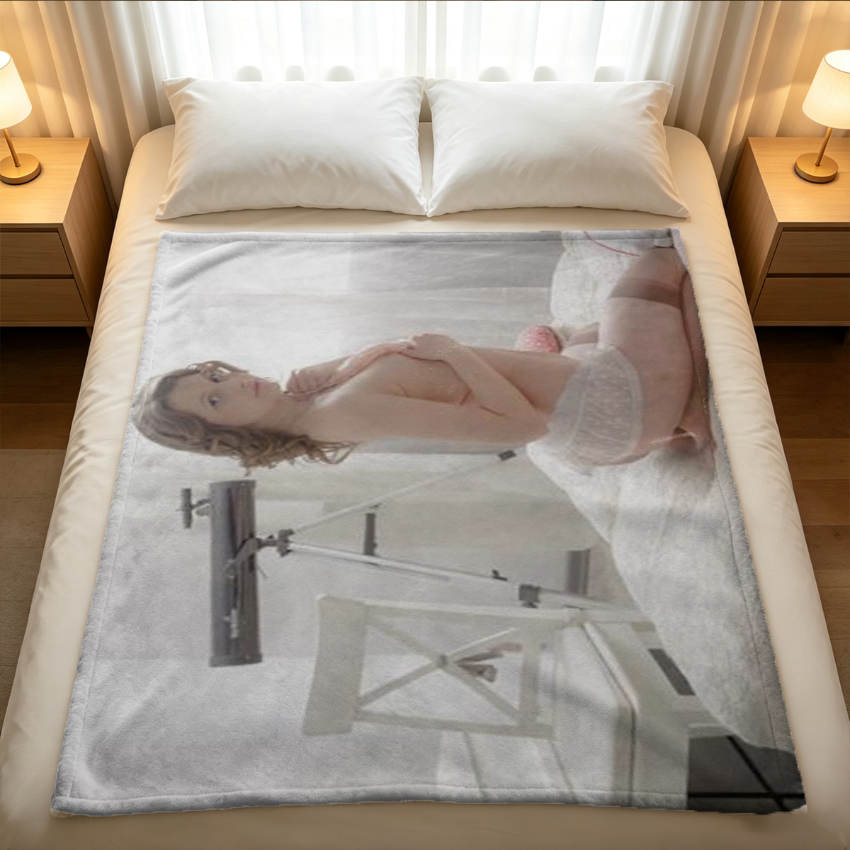A woman in black lingerie and stockings sitting on a bed. - Blanket