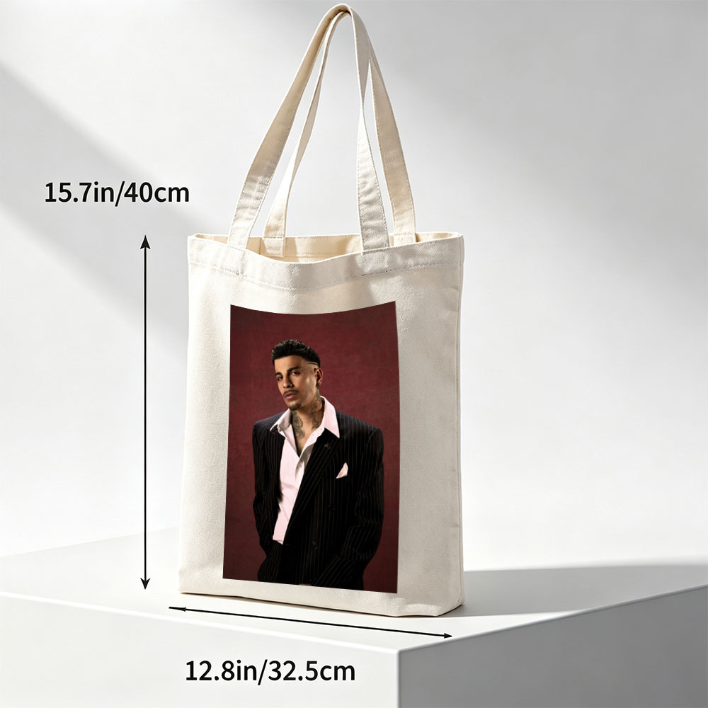 Maluma in a Pinstripe Suit Against a Deep Red Background - Canvas tote bags