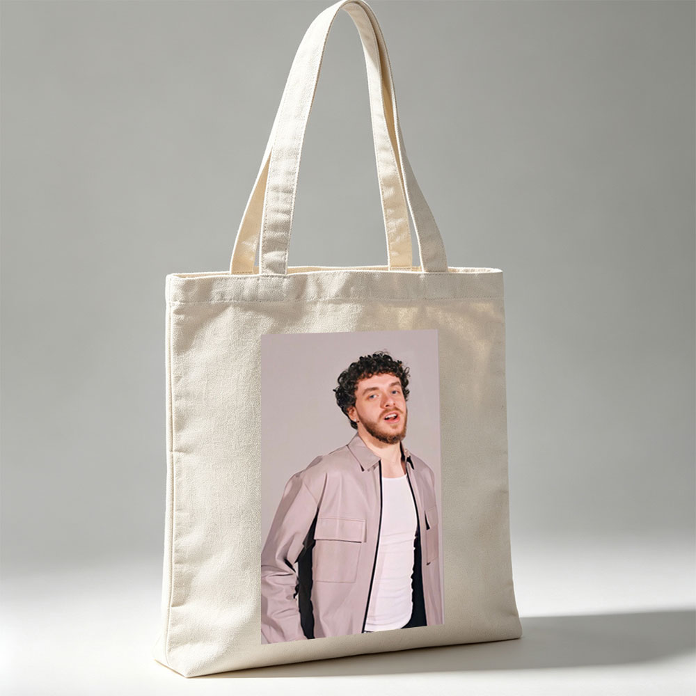 Jack Harlow in a Stylish Pose Wearing a Beige Jacket Over a White Shirt Against a Neutral Background - Canvas tote bags