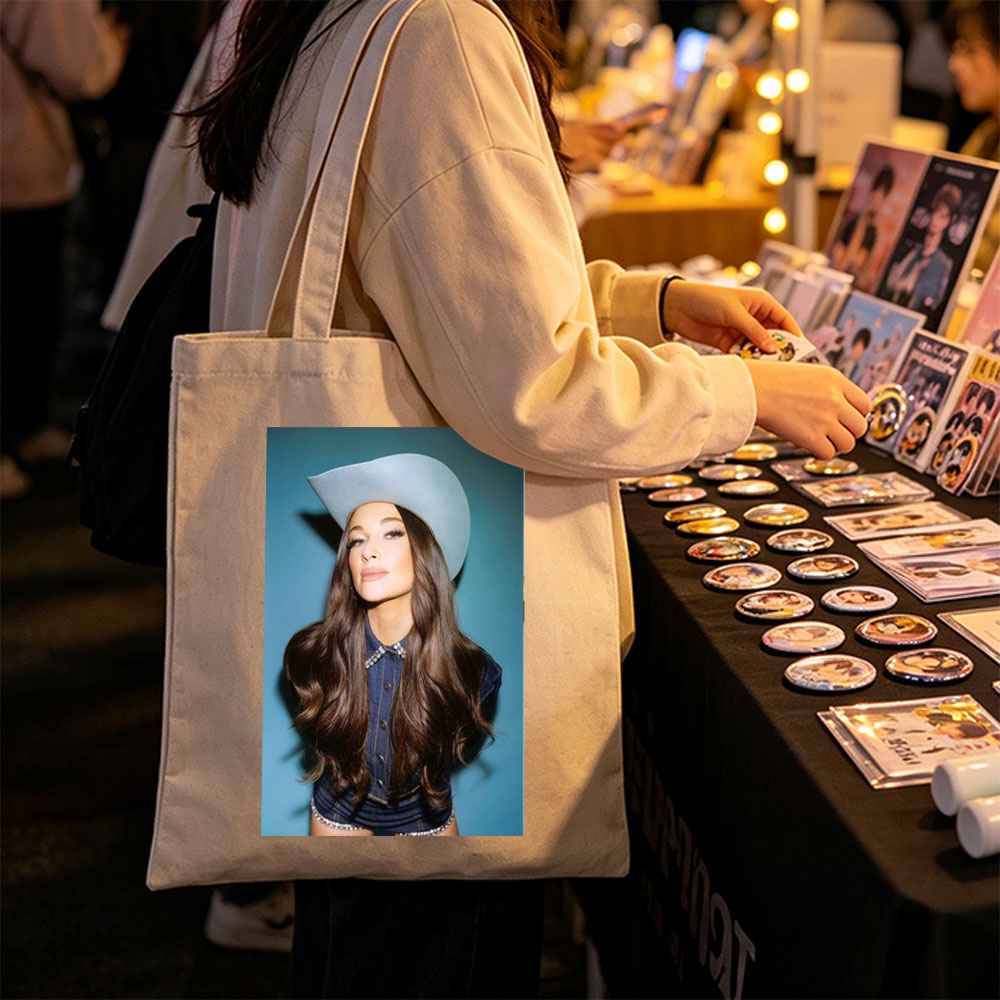 Kacey Musgraves in a Cowboy Hat and Denim Outfit Against a Blue Background - Canvas tote bags