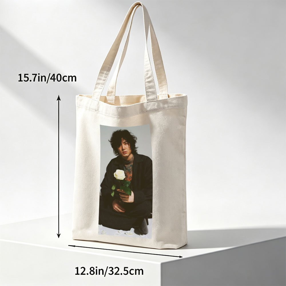 Yosuke Sugino Holding a White Rose in a Stylish Black Outfit with Petals Scattered Around - Canvas tote bags