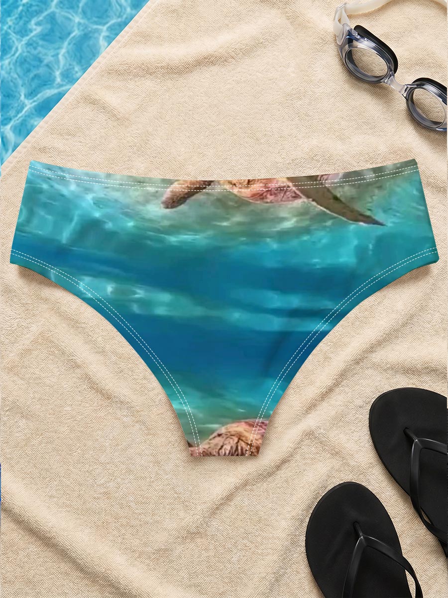 Sea turtles swim gracefully in clear blue waters, one near the surface and one gliding over sandy ocean floor. -  Men's swim trunks