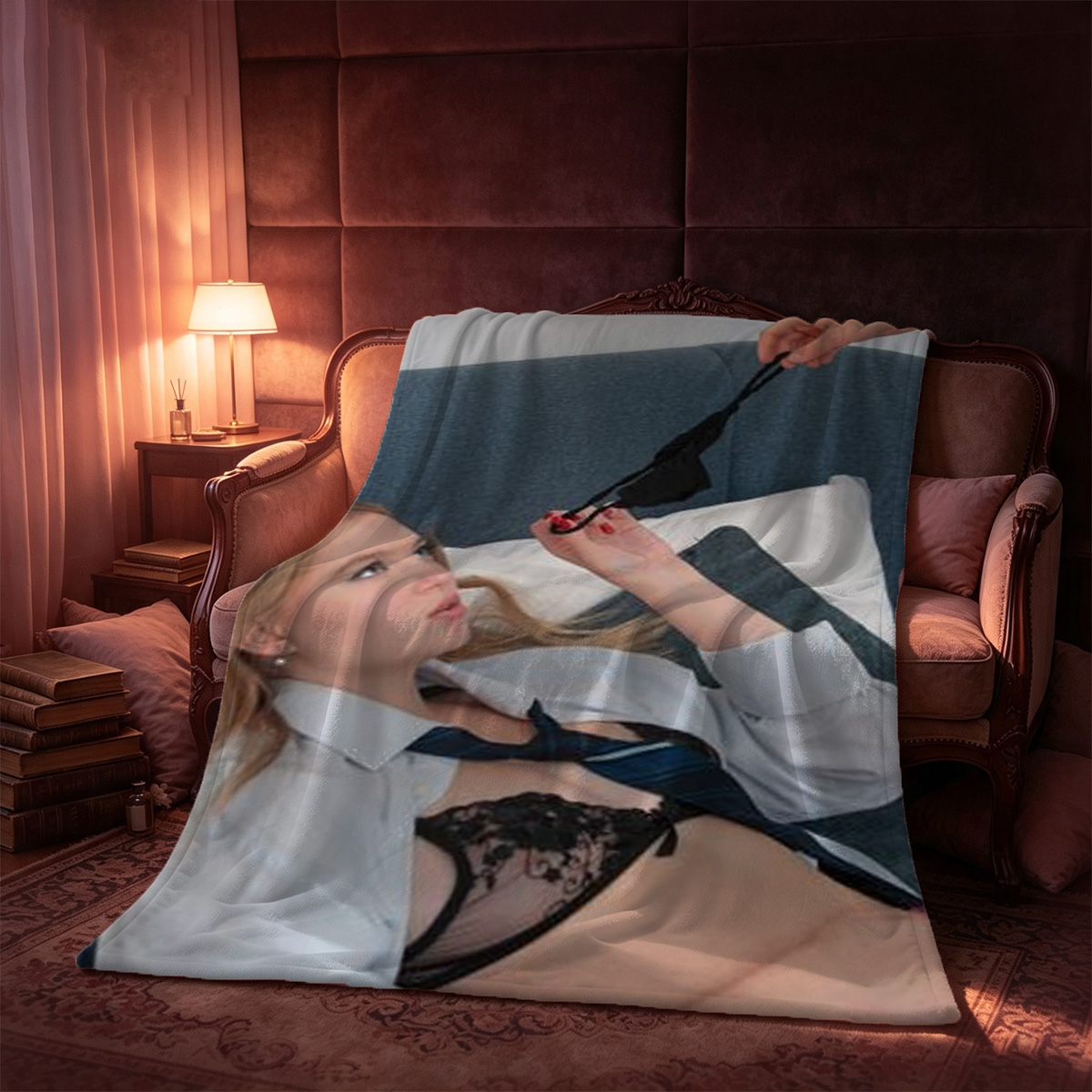 A young woman in a sheer black robe sits on a bed with an open suitcase of clothes in the foreground. - Blanket