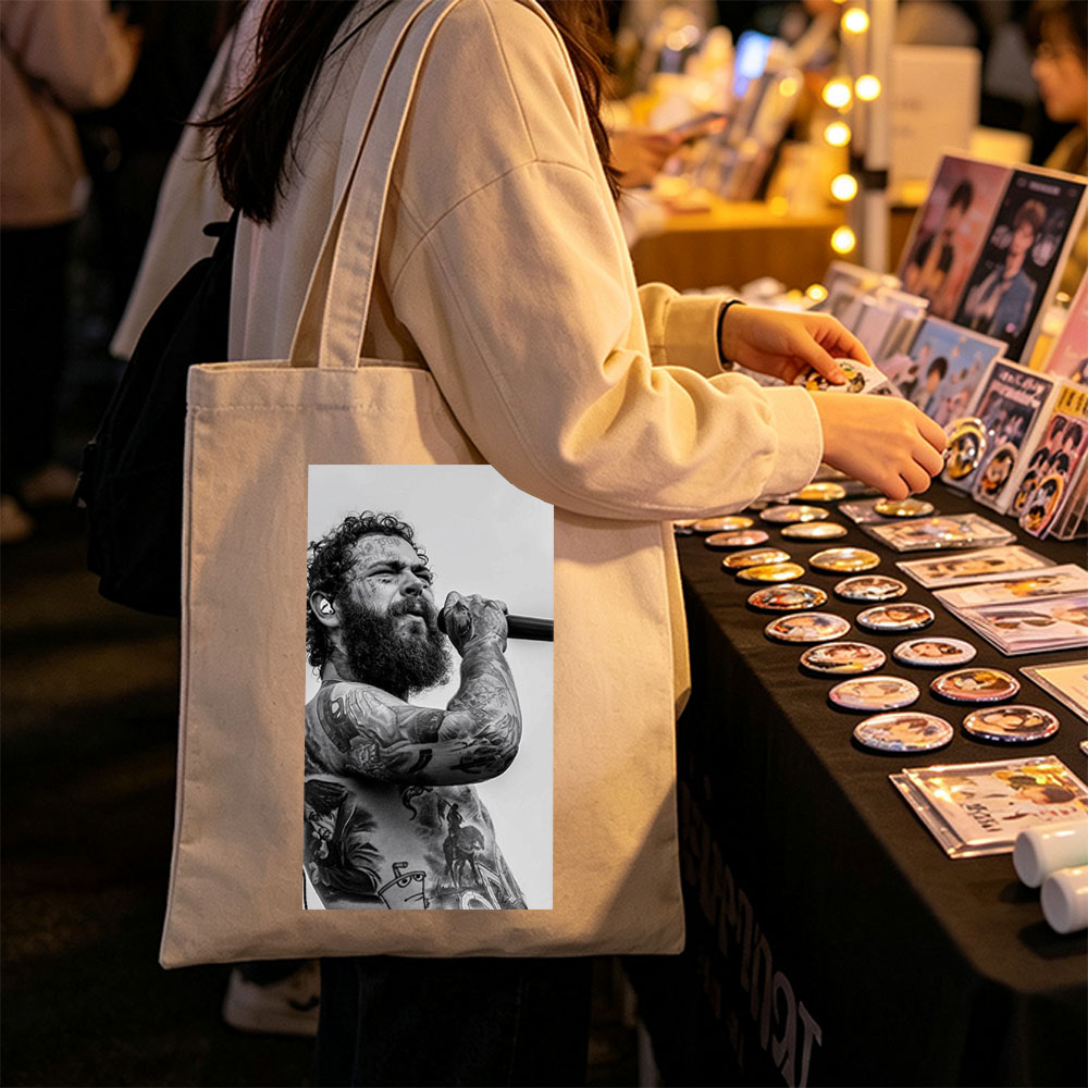 Post Malone Performing on Stage with Tattooed Arms and Beard in Black and White Photo - Canvas tote bags