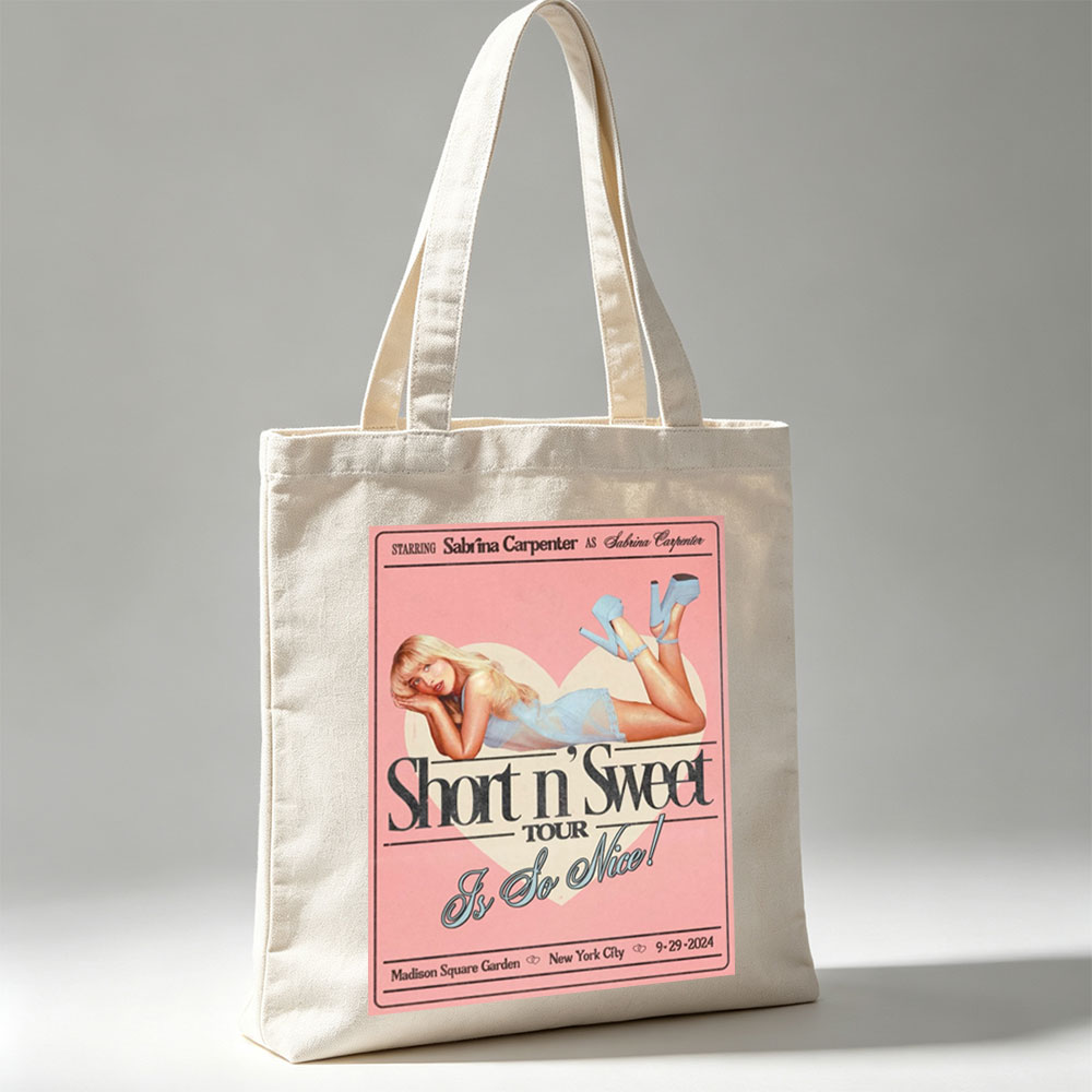 Sabrina Carpenter Short n' Sweet Tour Poster Featuring Her in a Blue Dress and Heels Lying on a Heart Background - Canvas tote bags
