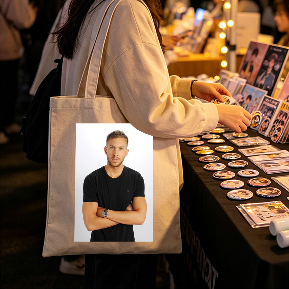 Calvin Harris Standing with Arms Crossed in Black T-Shirt Against White Background - Canvas tote bags