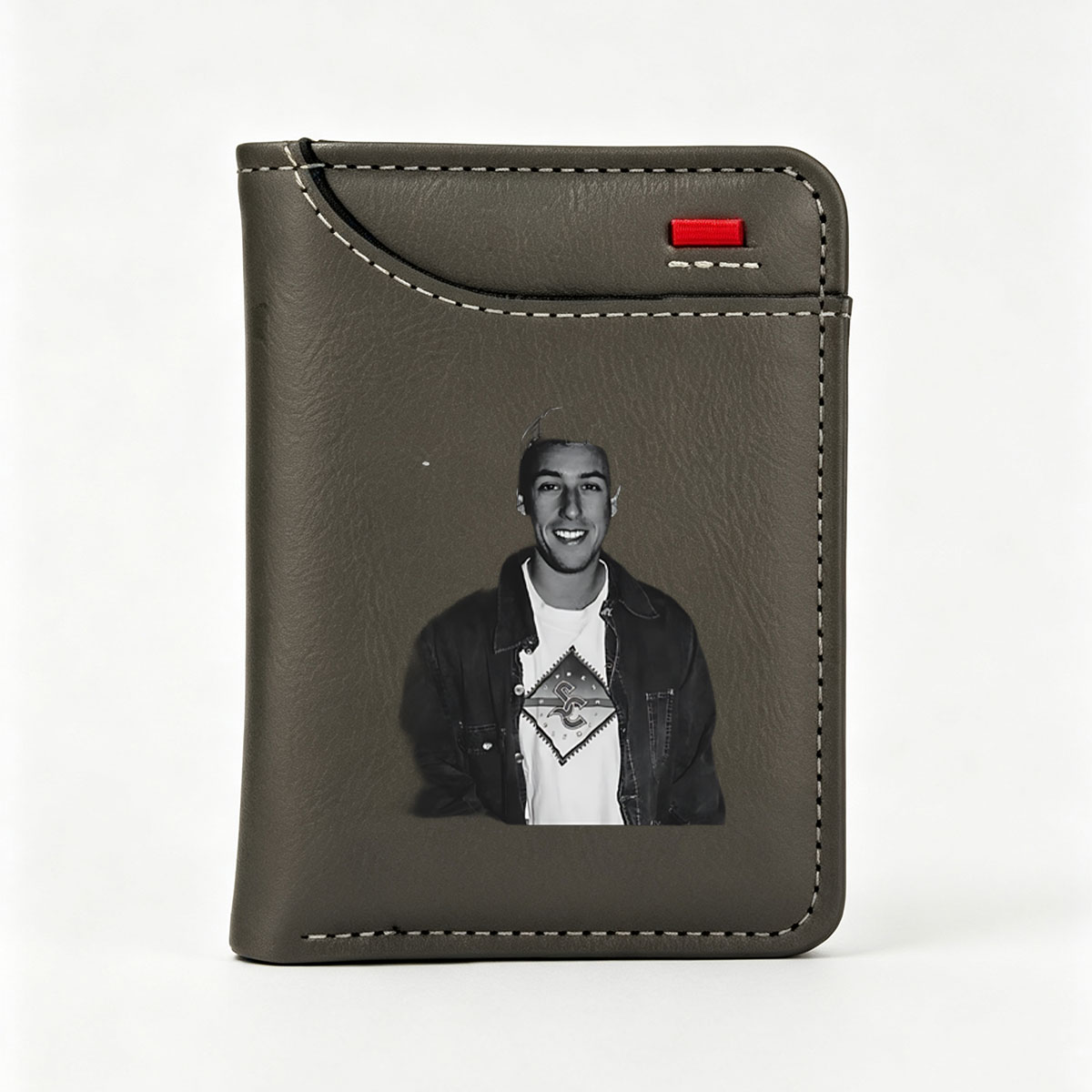 Young man in a cap and denim jacket with a graphic t-shirt, smiling at the camera. - Vertical Style Wallet