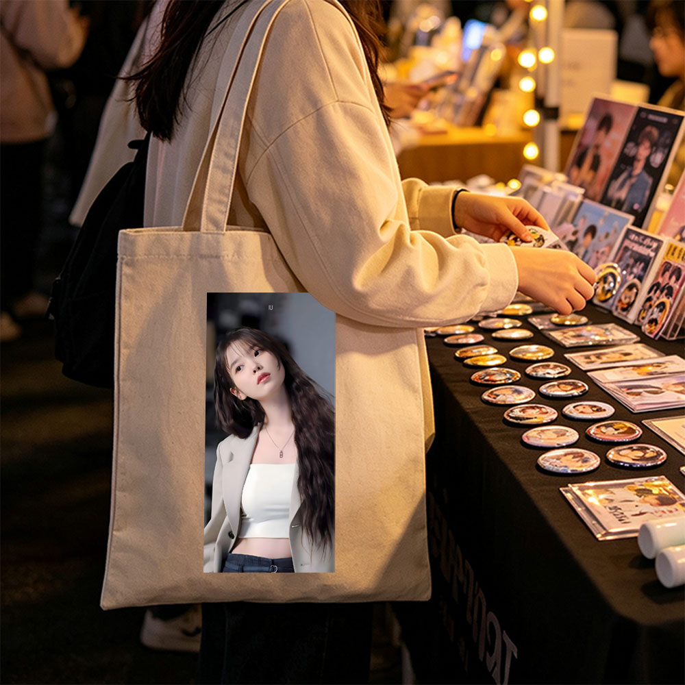 IU in a stylish outfit with a beige blazer and white crop top, showcasing her long wavy hair and elegant necklace. - Canvas tote bags