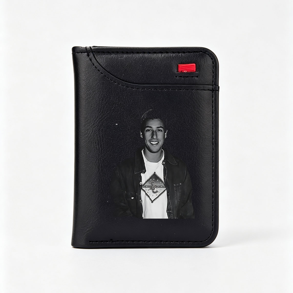 Young man in a cap and denim jacket with a graphic t-shirt, smiling at the camera. - Vertical Style Wallet