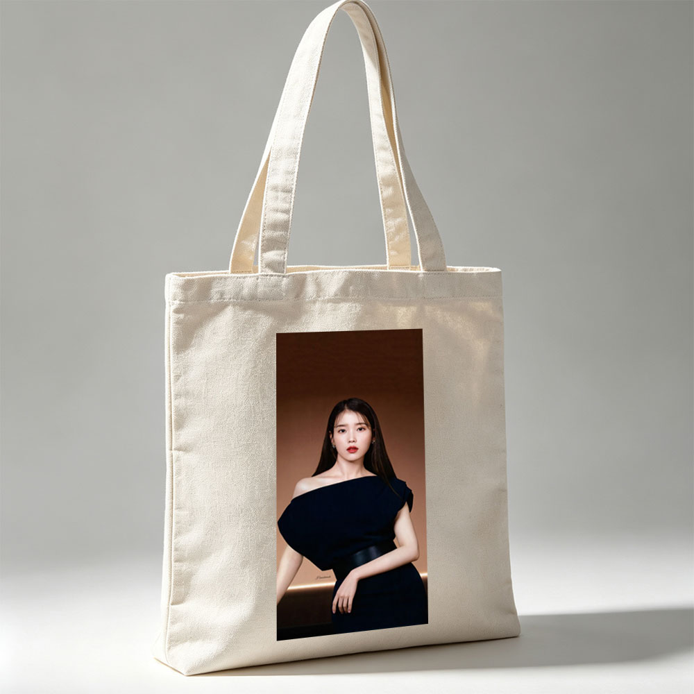 IU in Elegant Black Off-Shoulder Dress Against Warm Brown Background - Canvas tote bags