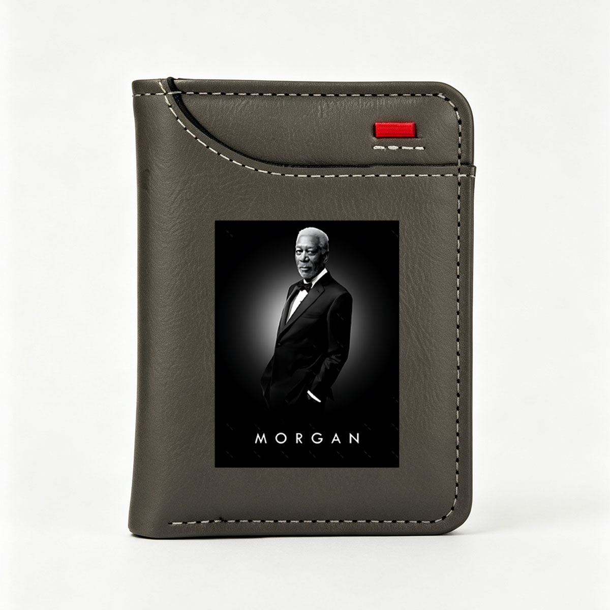 Morgan Freeman in a formal black suit, standing confidently against a dark background with the name 